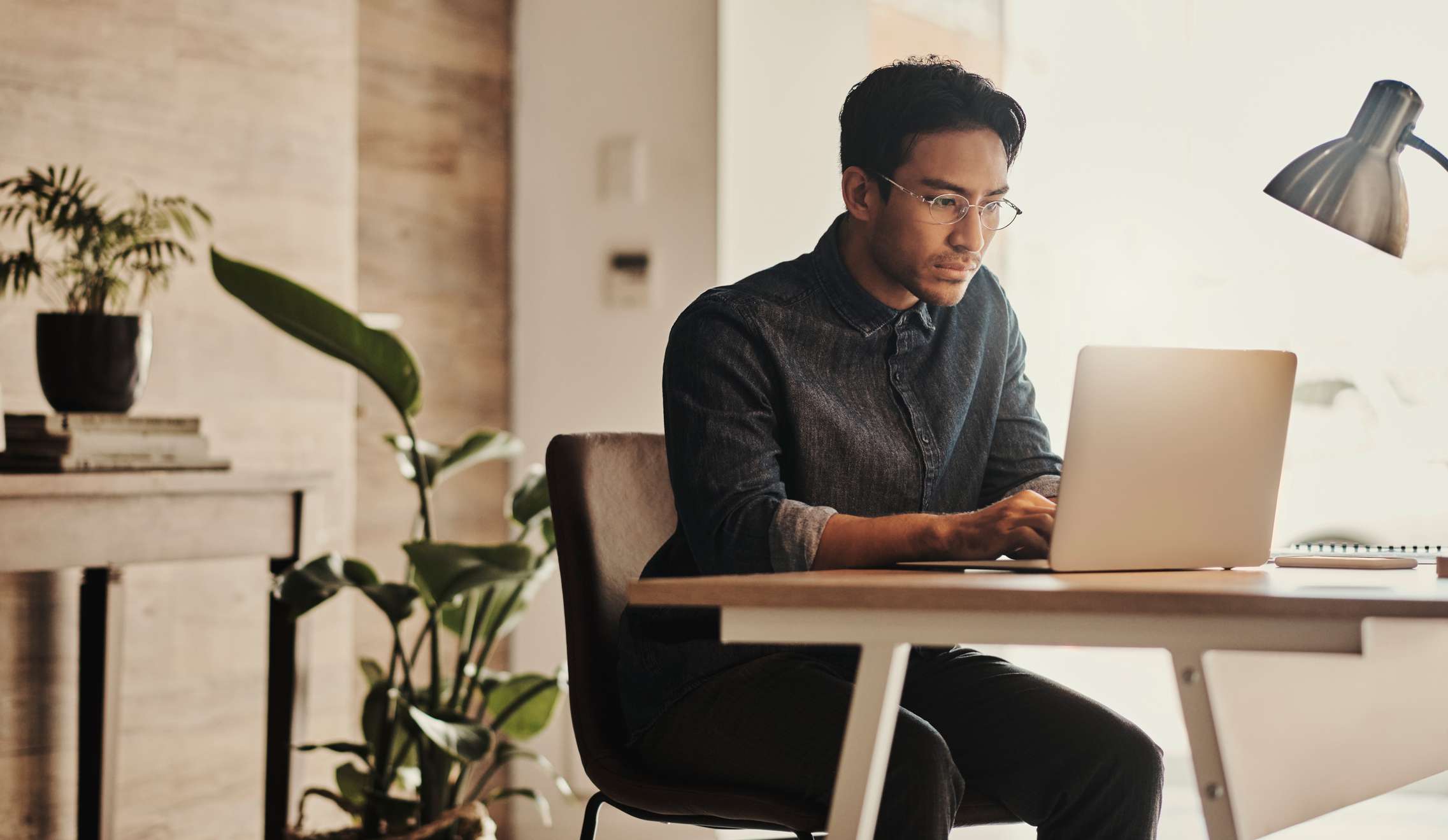 A man works on a laptop