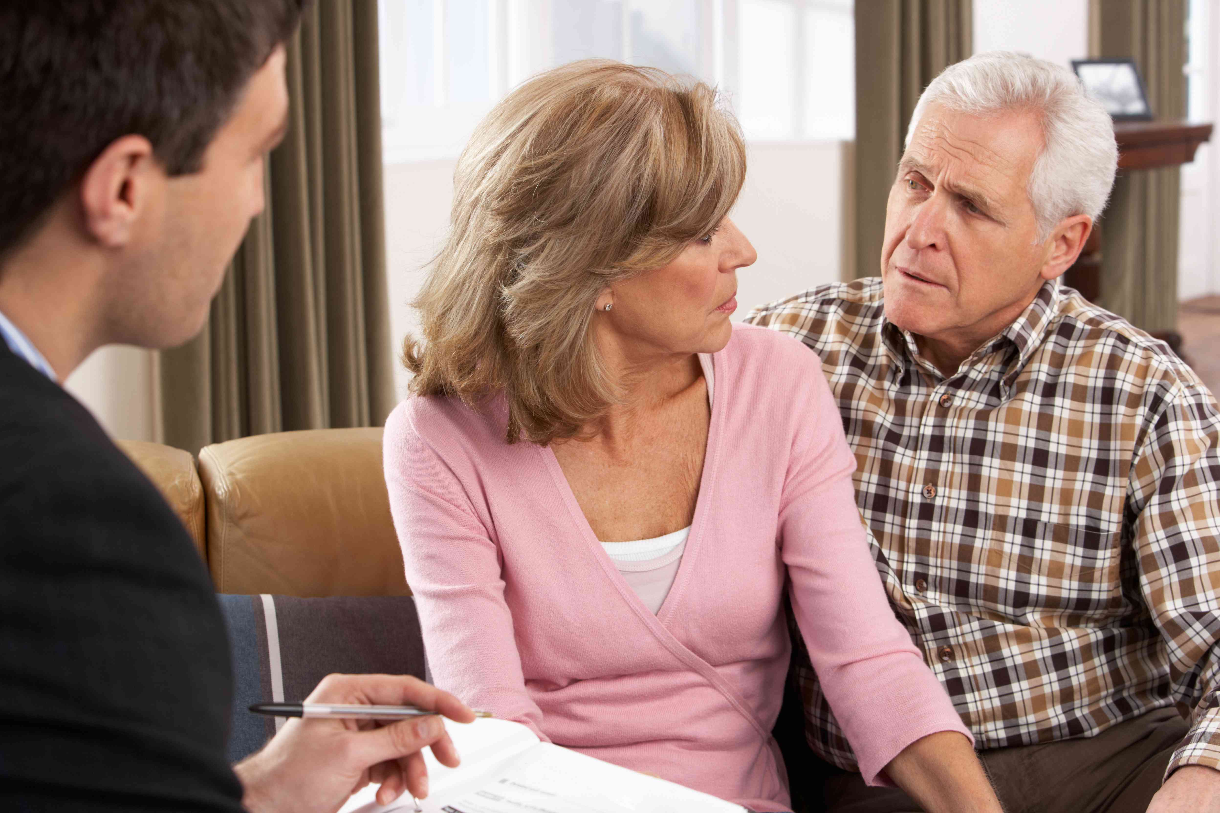 Couple talking to their financial advisor