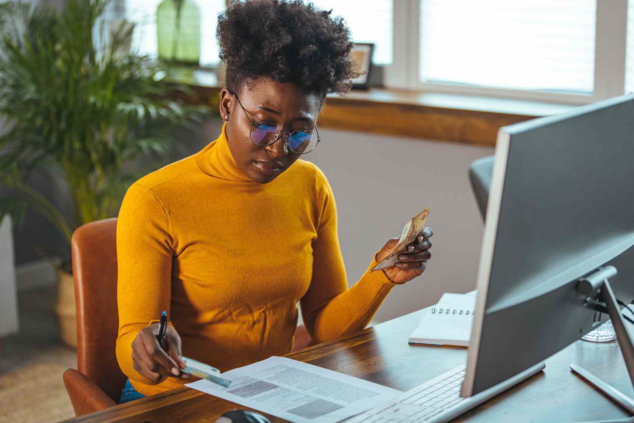 Woman working on the finances of her personal loan business