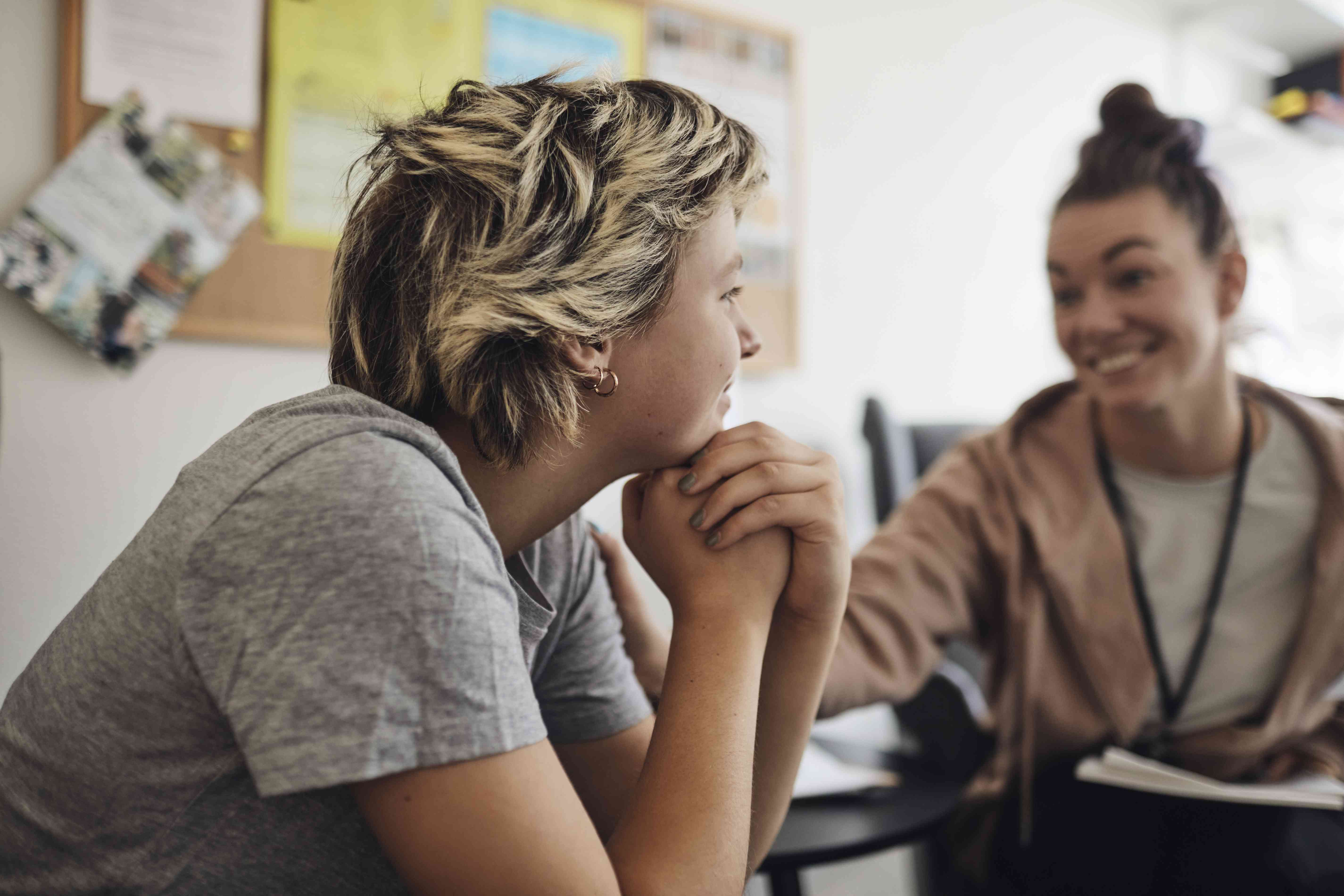 Young woman talking to a counselor about her mental health.