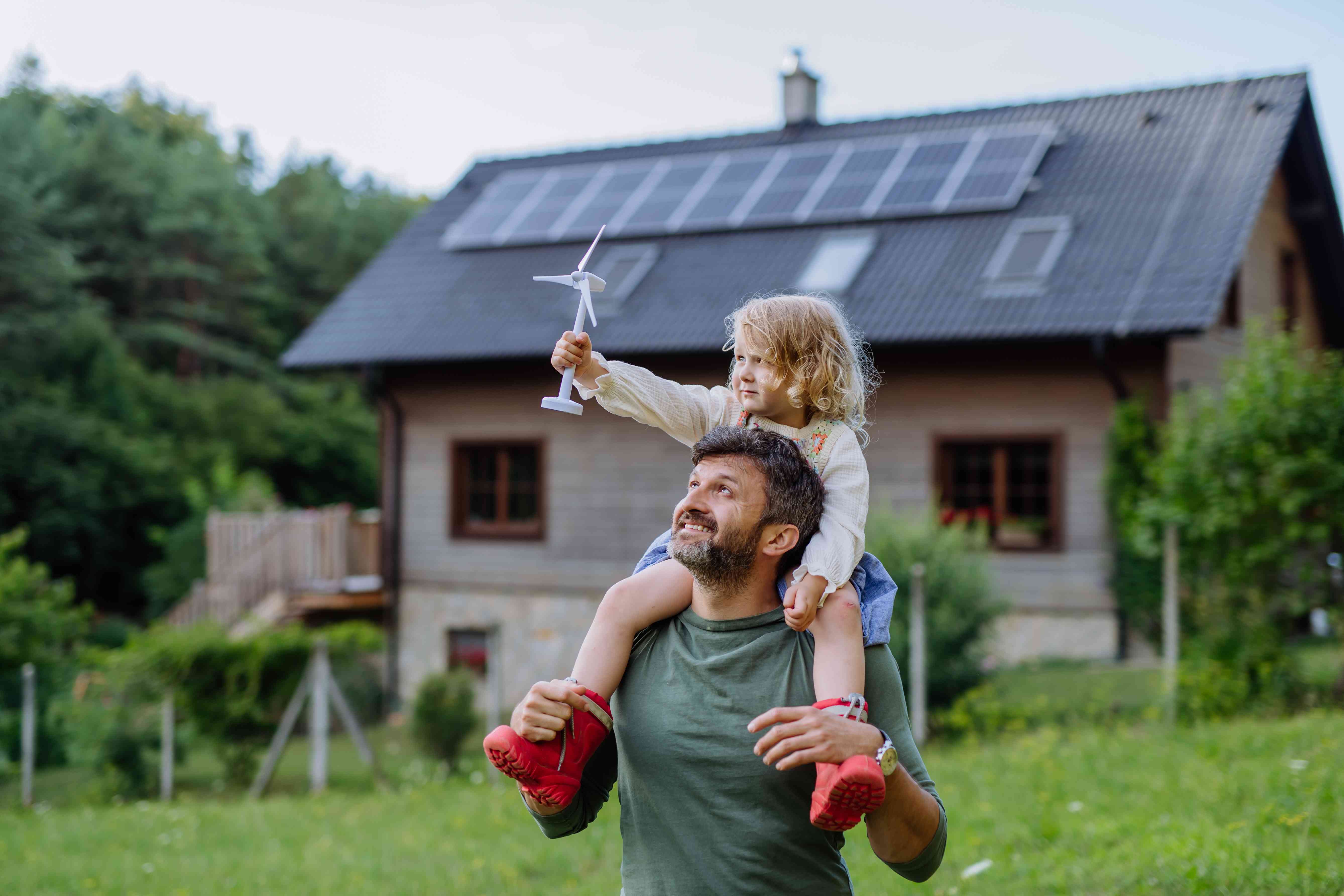 Father and child in front of home