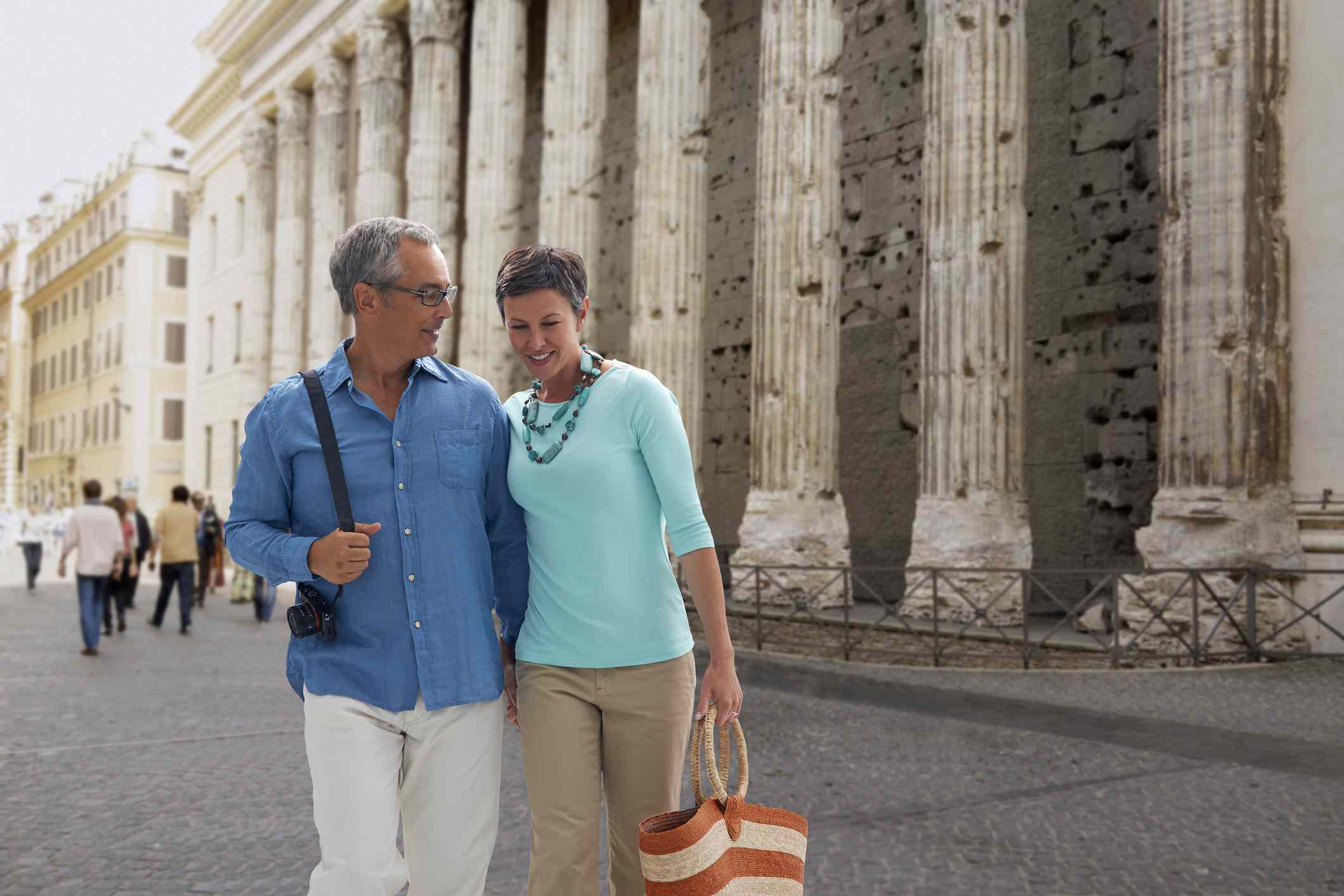 Couple walking in Piazza di Pietra, Italy