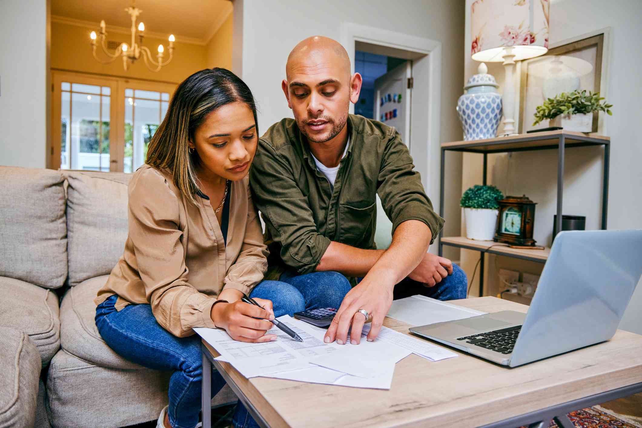 A couple reviews paperwork in their home.