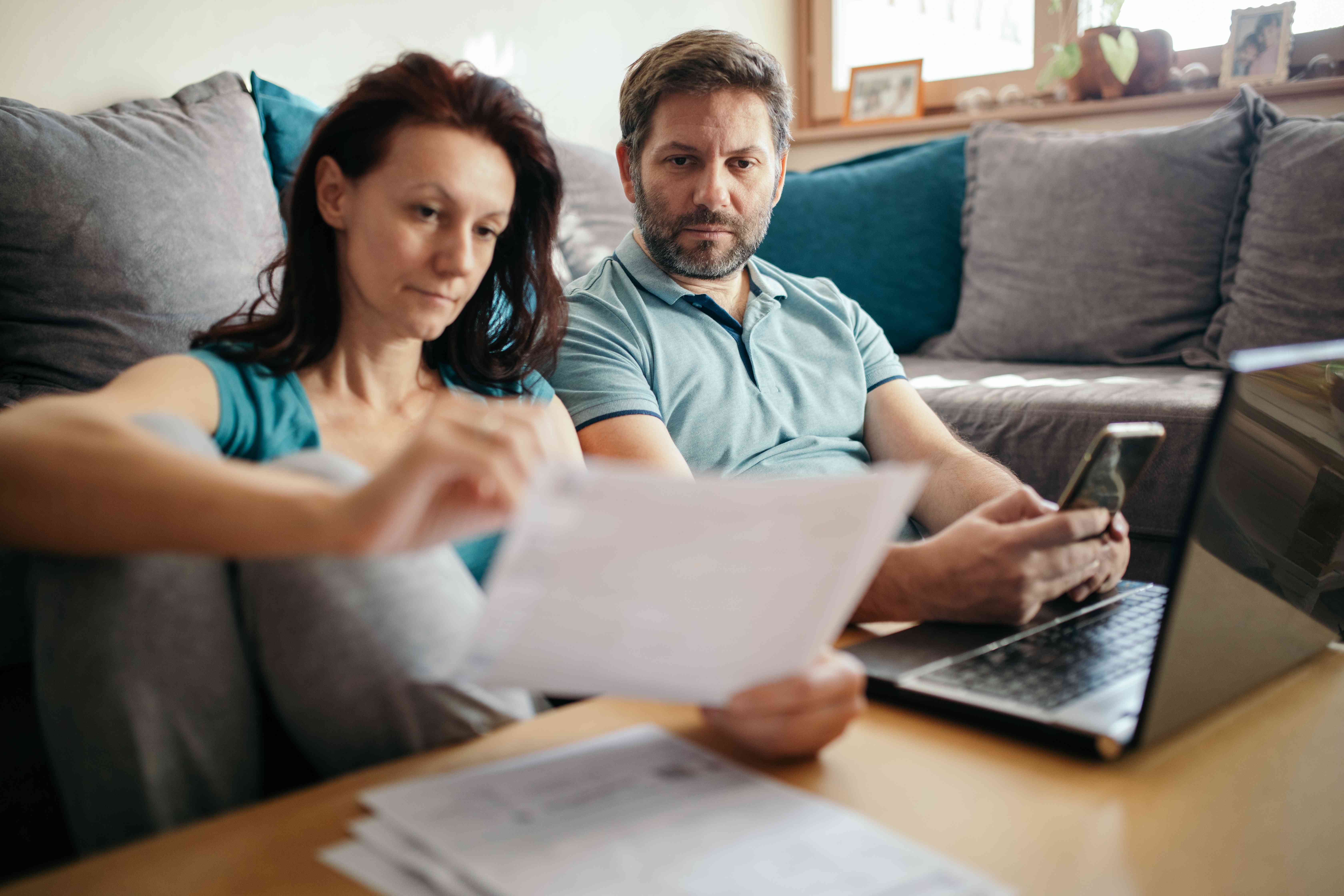 Married couple looking at papers and trying to make ends meet