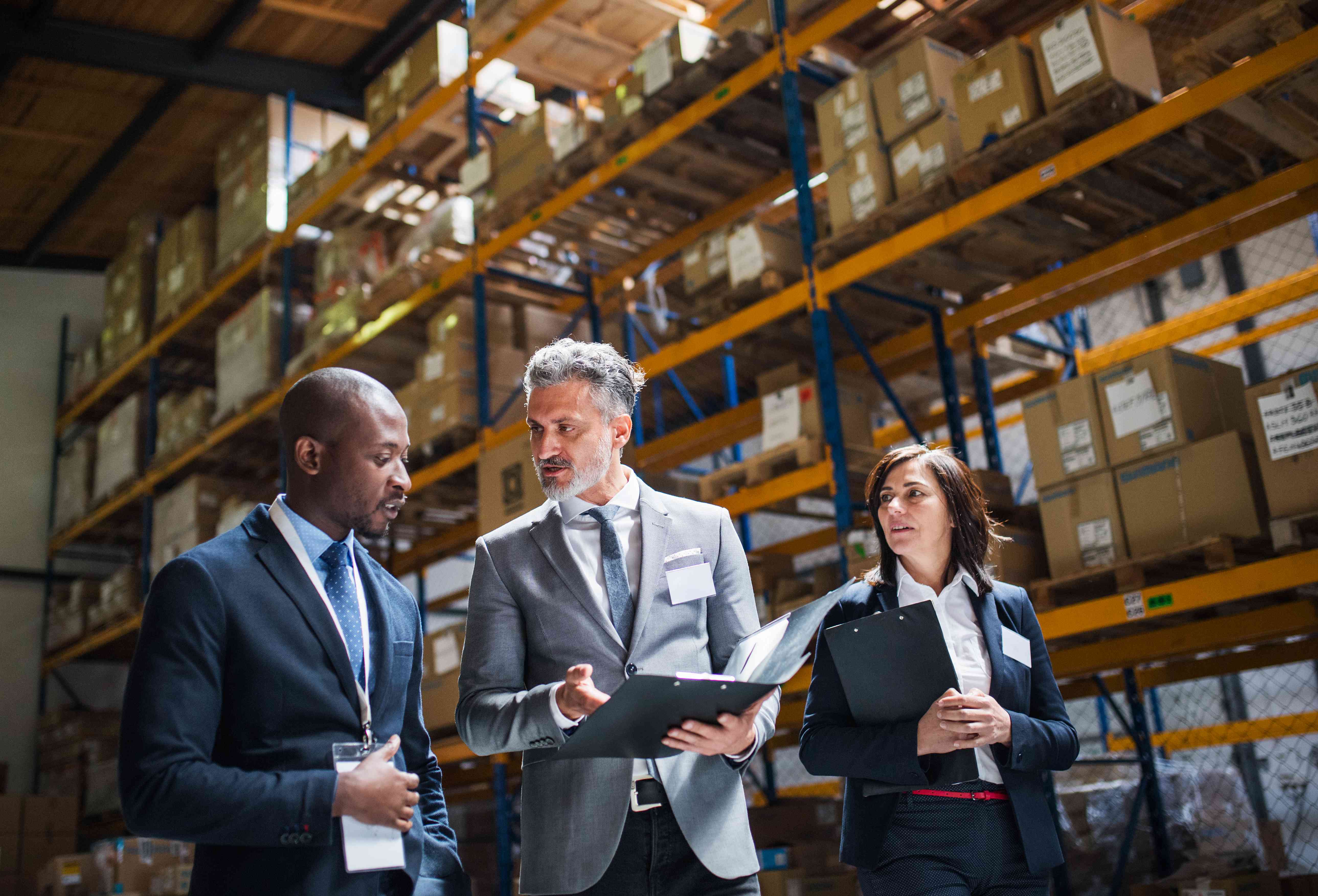 Business people discussing financing options inside a warehouse