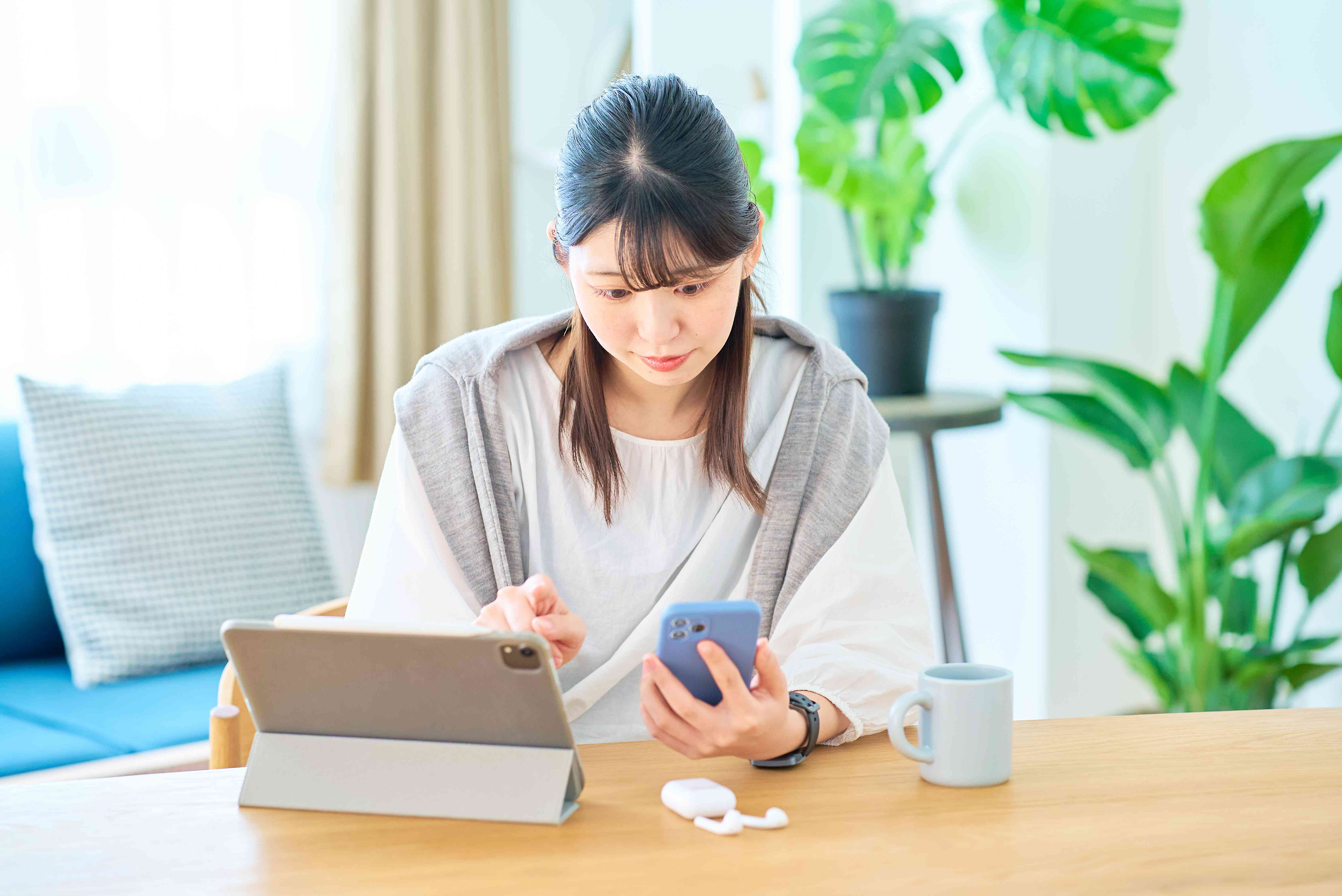 Young woman checking her bank account on her phone