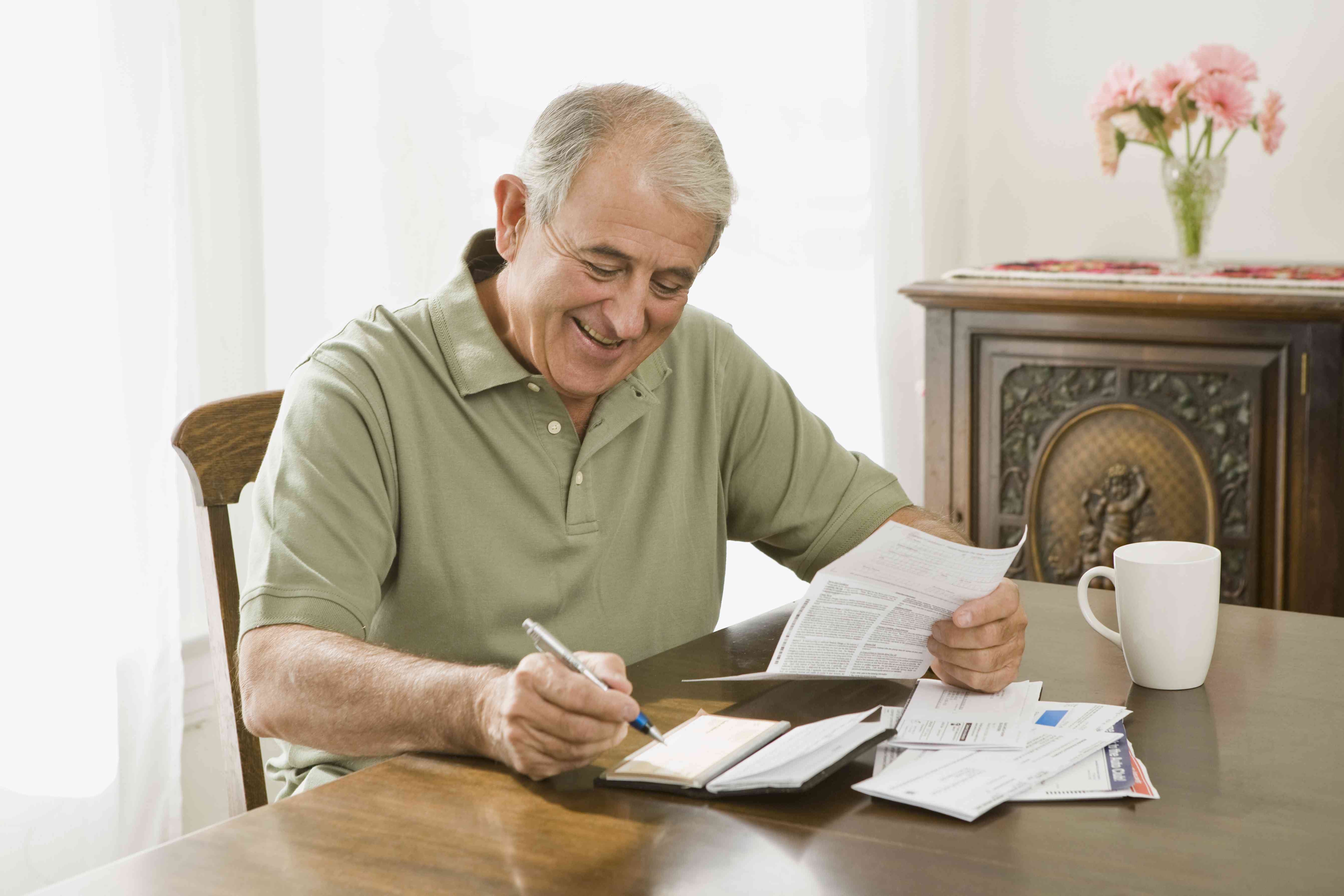 A person paying bill by checkbook.