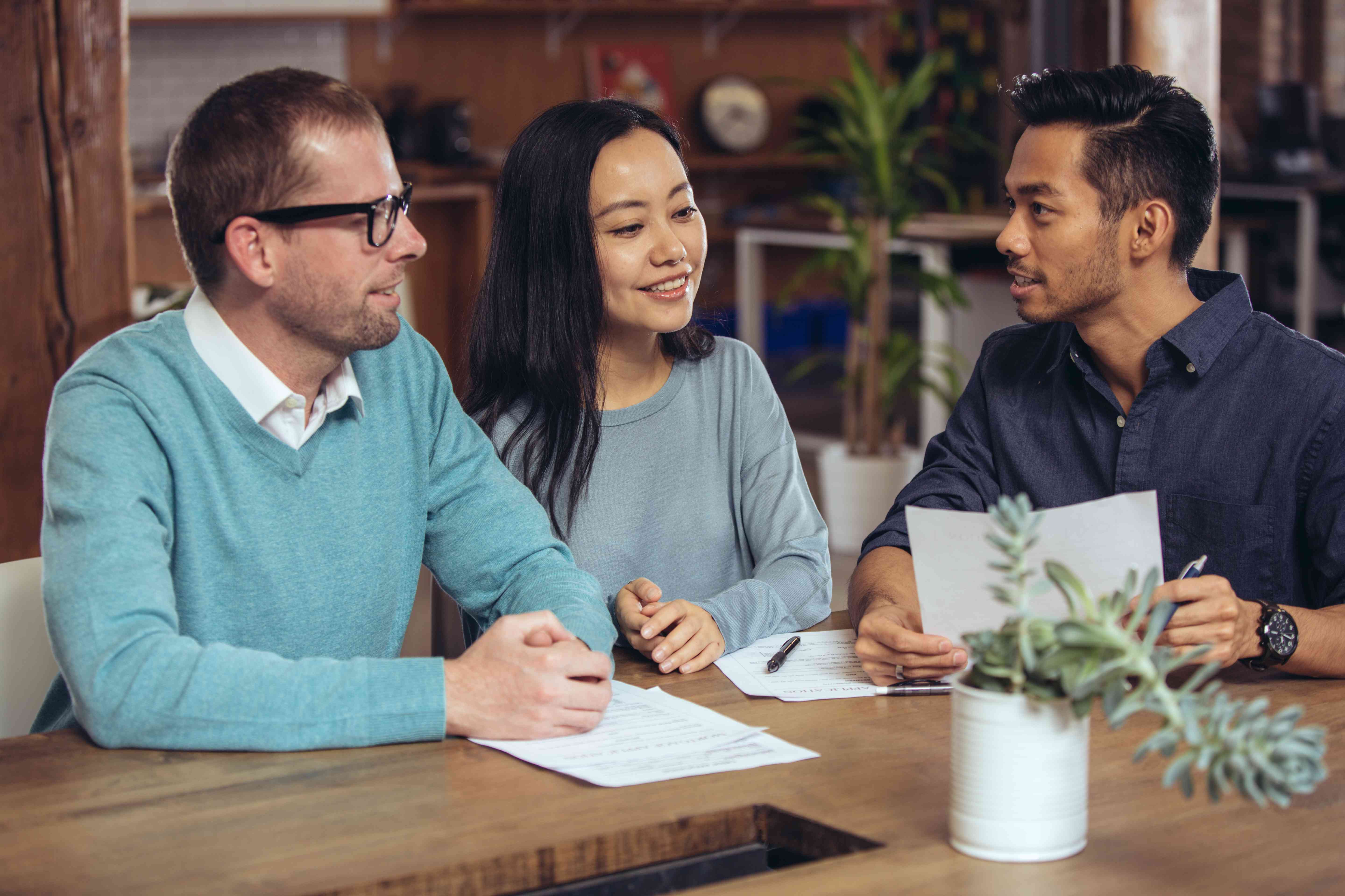 Couple co-signing a lease contract with real estate agent.