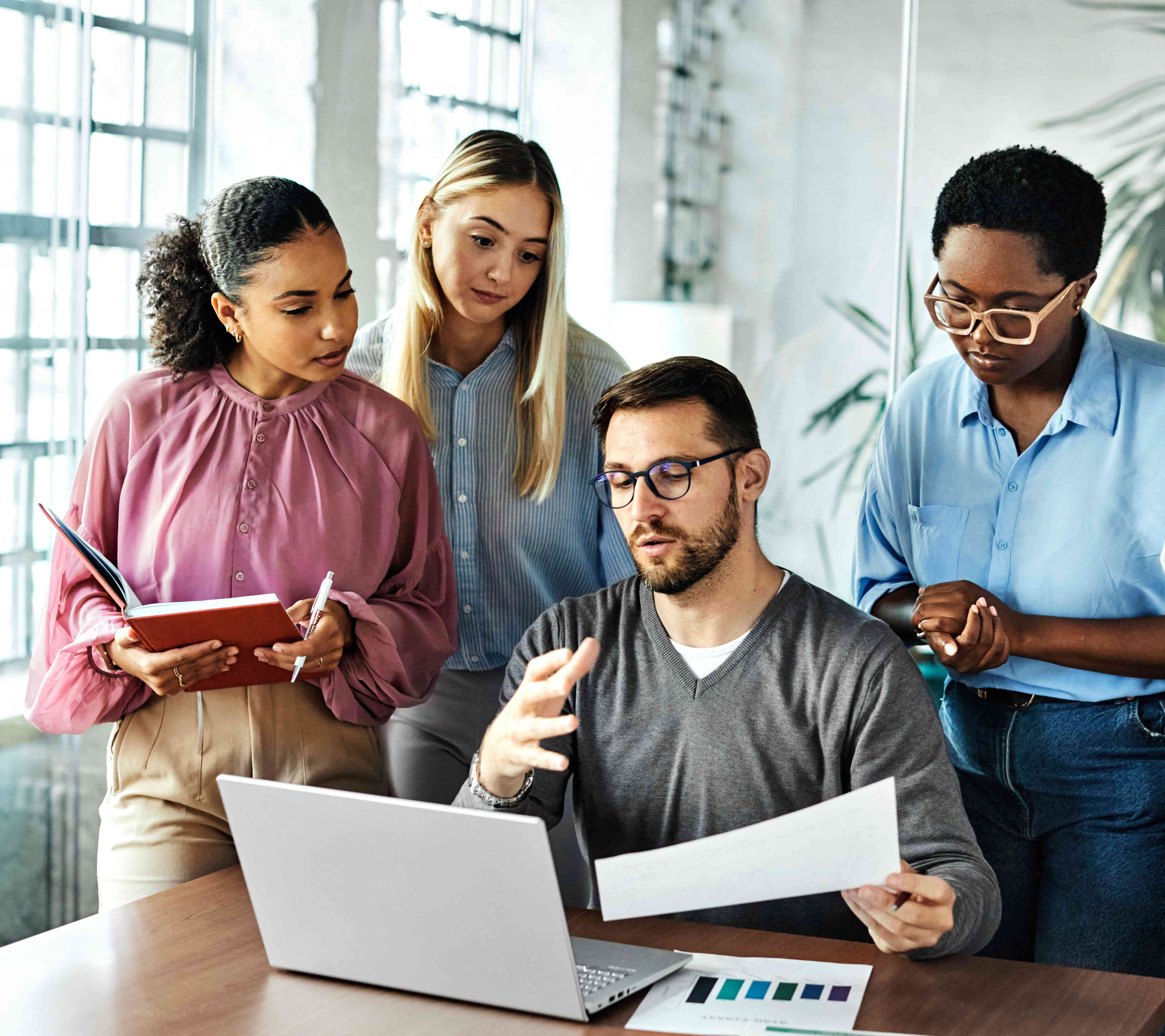 Group of people in an office discussing about company's accounts