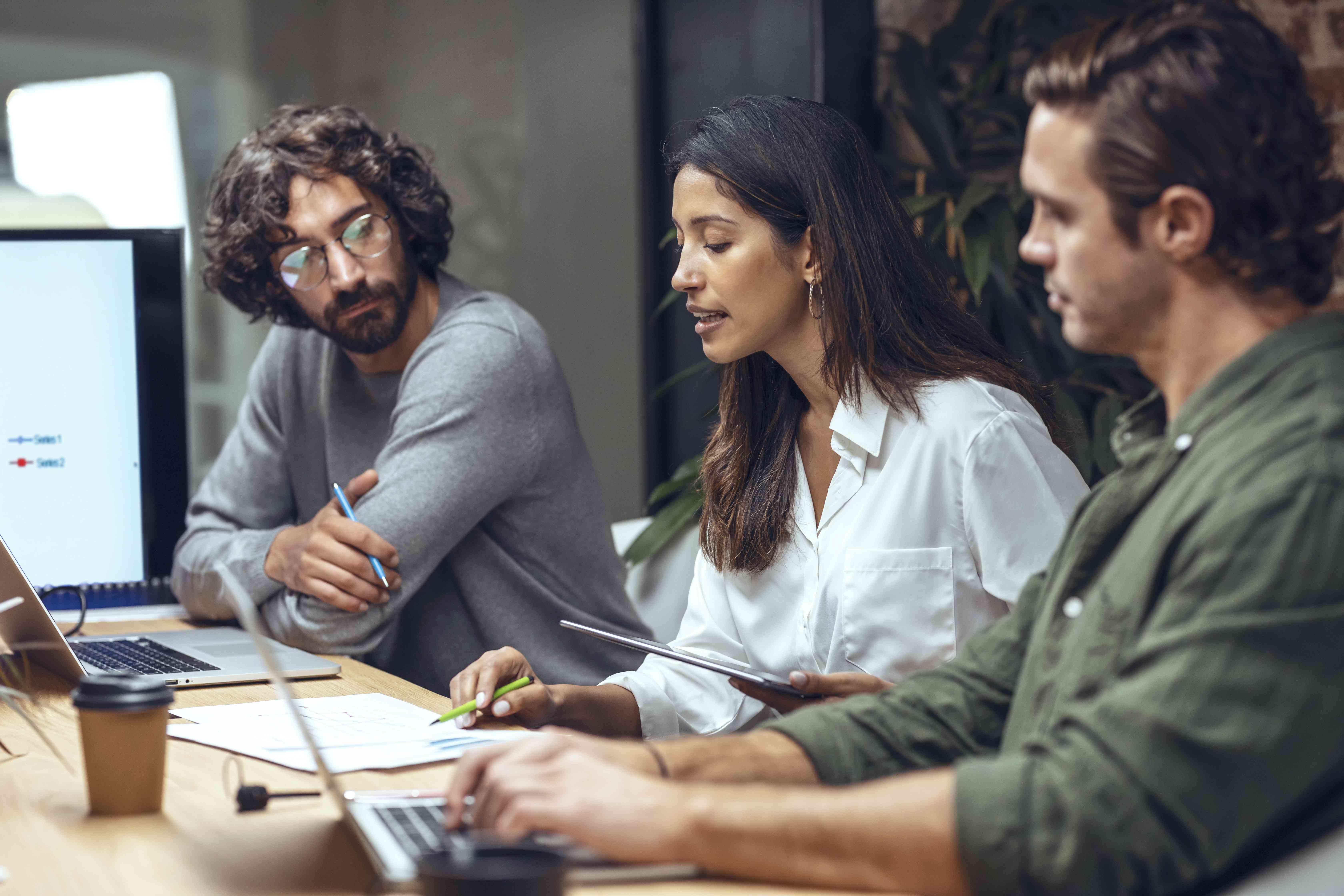 People in a business meeting evaluating the risk of investing in a public company using Zeta model.